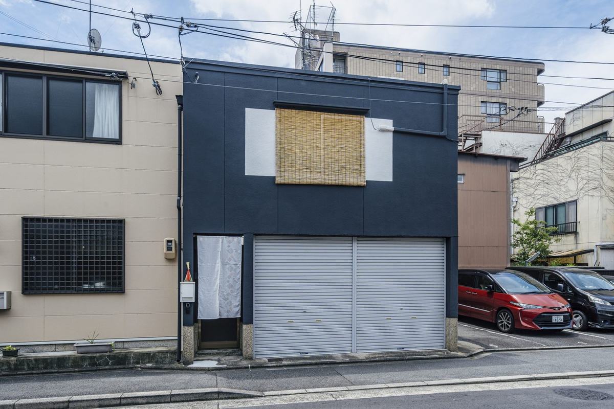 The building seen from along the street, with beige neighbours on either side